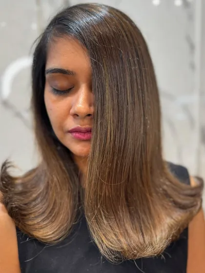 A close-up on the subtle, blended highlights in this straight hair balayage.