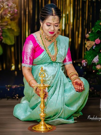 A traditional moment of lighting the lamp, bringing blessings and light to the celebration and the baby on the way.