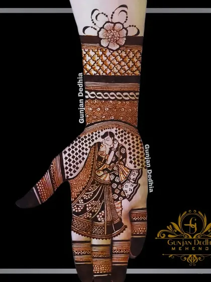 An intimate couple portrait on the palm, with delicate floral and geometric patterns extending up the arm. This is a beautiful blend of modern portraiture and traditional design.