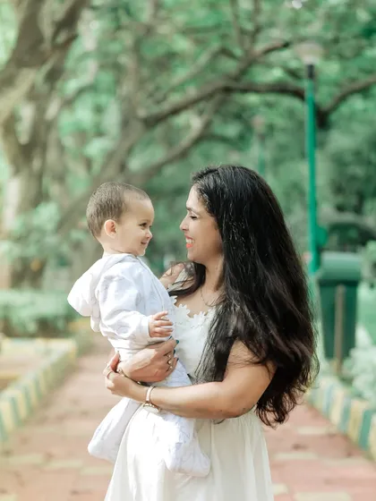 A mother and child share a loving gaze in a beautiful outdoor setting. These are the precious, unposed moments that tell the real story of your family's bond.