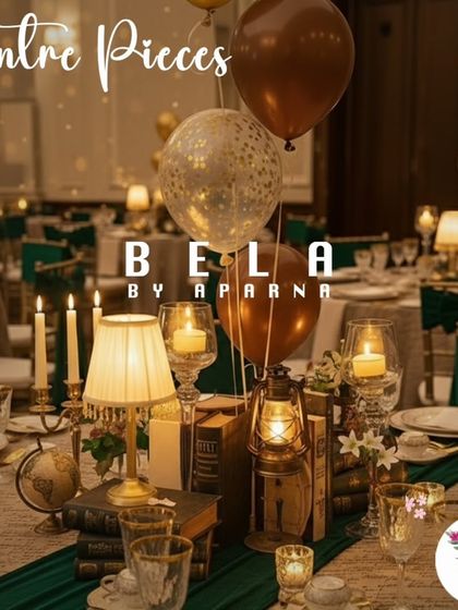 This centerpiece perfectly captures the vintage library theme. It features a stack of old books, a classic table lamp, a vintage lantern, and candles, all arranged to create a warm and literary focal point on the guest table.