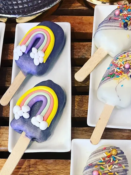 Fun and whimsical rainbow cakesicles, a perfect and mess-free treat for a baby shower or kids' party.