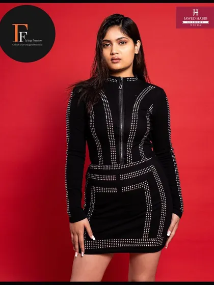 Another pose of the model in the black dress, showing the versatility of the look created by our students.