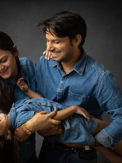 A candid moment of play during a family session. Holding their daughter like this creates a dynamic and loving image full of movement and laughter.