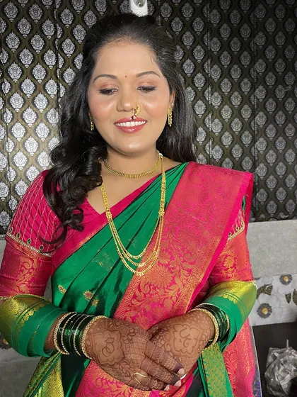 My bride Urvashi, ready for her engagement in a beautiful green and pink saree. The makeup is fresh and vibrant.