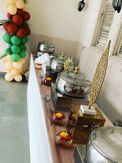 A side view of the buffet table at a birthday event, showing the elegant decor and balloon arrangements that add to the festive atmosphere.