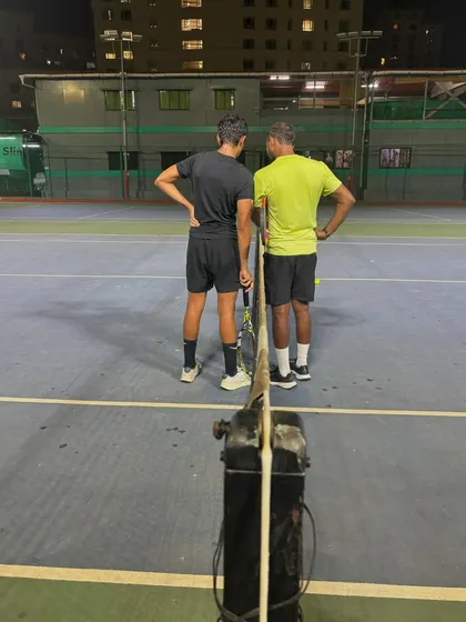 A moment between coach and student to discuss strategy and technique. This personalized feedback is crucial for player development.