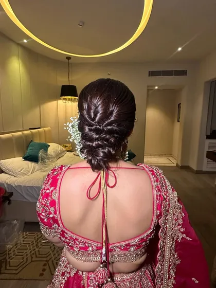 The full back view of the modern braided updo. This style is perfect for brides who want something unique and structured, moving away from the traditional simple bun.