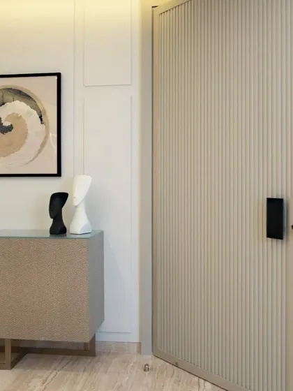 A close-up of a fluted door with a modern black handle. This detail adds texture and a contemporary feel, contrasting beautifully with the smooth walls and polished floor.