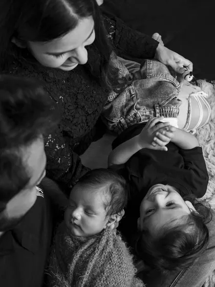 An overhead view of the whole family enjoying a quiet moment together. This perspective creates a feeling of intimacy and closeness.