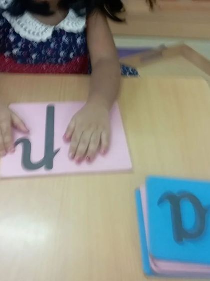 The Sandpaper Letters are a foundational language material. By tracing the tactile letter with their fingers, children build a muscle memory of the letter's shape while learning its corresponding sound.