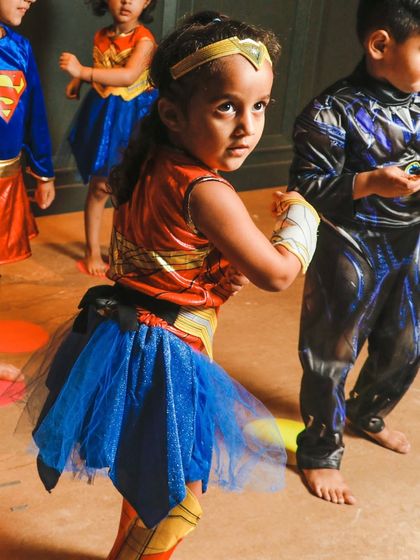 This young Wonder Woman is captured mid-move, showing the dynamic energy of our kids' classes.