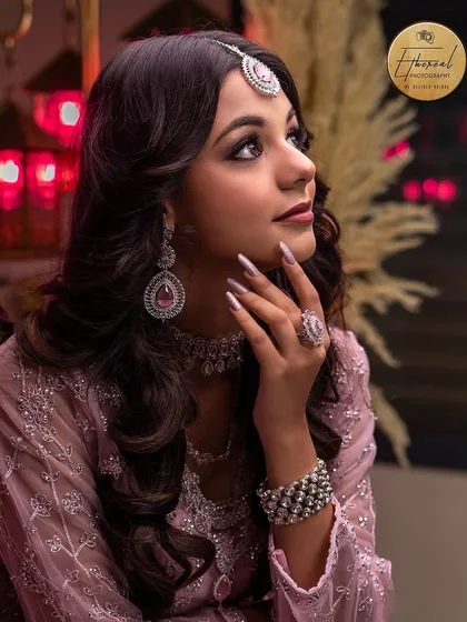 A classic beauty portrait with a focus on the model's profile and the intricate jewellery. The soft lighting and thoughtful pose create an elegant and timeless image for any portfolio.