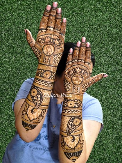 Full coverage bridal mehndi for a client, featuring elephants and paisleys. This design extends up to the elbow for a complete bridal look.