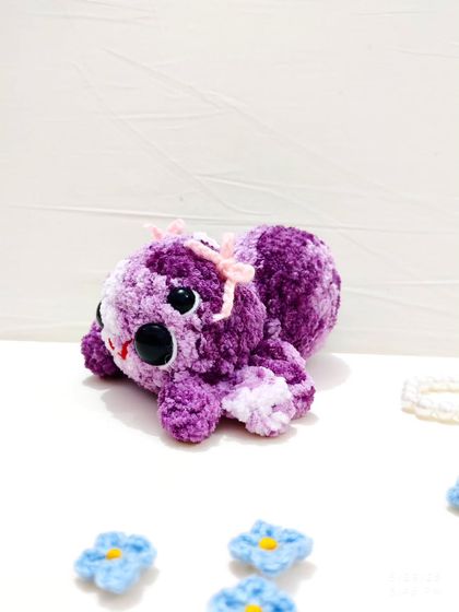 Another angle of the adorable, ribbon-adorned spider plushie.