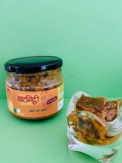 A jar of my classic Aam ka Achaar next to a bowl of it. This pickle is a staple in every Indian household, and I make it with the utmost care.