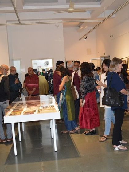 A wide shot of the crowd at the preview of the 'Hand Prints' exhibition.