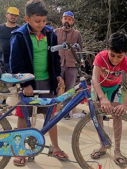 Two young boys get to work on a bicycle at a repair cafe event in Hyderabad. We provide the tools and the guidance, but the real learning comes from doing it yourself.