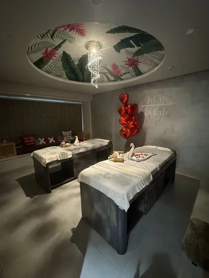 This is where you can truly escape and reconnect. My private couples' treatment room is a sanctuary designed for shared serenity, featuring two massage beds under a beautifully painted ceiling and soft, ambient lighting to create a romantic and peaceful atmosphere.