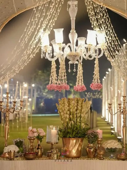 Celebrating 25 years of love with timeless elegance. A floral-draped chandelier and a console table with vintage brass candelabras and fresh tuberoses created a fragrant and beautiful welcome for the anniversary celebration.