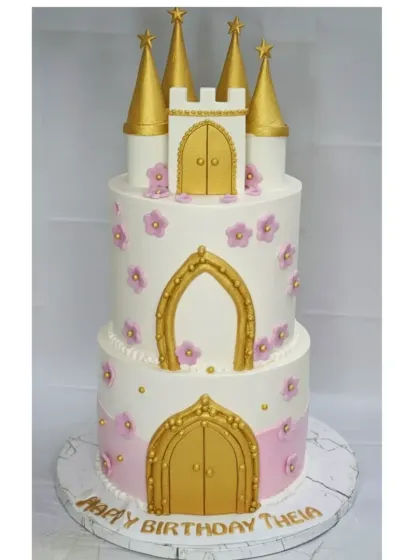 A fairytale castle cake for a princess's birthday. This 5 kg, two-tier cake was a mix of two flavors, fresh mixed fruit and chocolate truffle, and decorated with golden doors and delicate flowers.