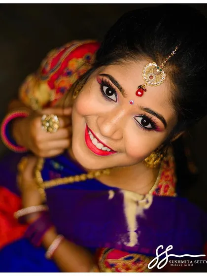 A close-up of a vibrant South Indian bridal makeup look created for a model shoot. I focused on creating flawless, camera-ready skin with bright, defined eyes and a cheerful pink lip to complement the traditional attire.