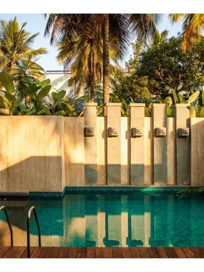 For this vacation home, we designed a series of stone water spouts that act as functional art for the pool area. The design creates a gentle sound of flowing water and a beautiful play of light and shadow, turning a simple poolside wall into a point of calm and sensory delight.
