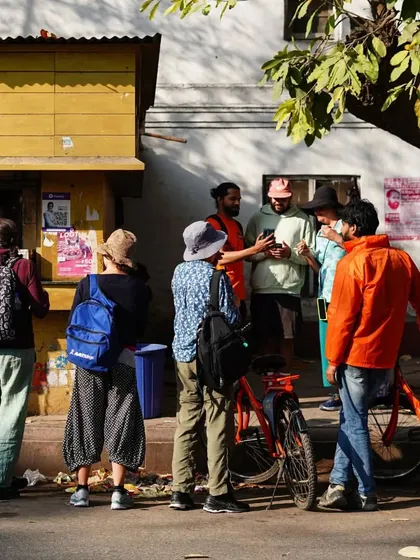 A group gathers around a local chai stall, a typical scene from our Raj Tour in New Delhi. It's a perfect break to chat, recharge, and soak in the local atmosphere.
