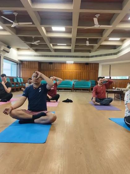 Here, students engage in Nadi Shodhana, or alternate nostril breathing. This fundamental pranayama technique is taught in my classes to purify the energy channels, balance the left and right hemispheres of the brain, and create a state of tranquility.