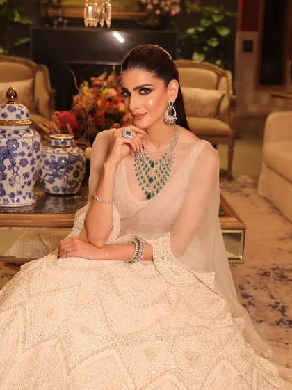 An ivory lehenga calls for makeup that is both elegant and radiant. For this look, I focused on a soft glam style with a flawless base, subtly smoked-out eyes, and a neutral lip, letting the bride's natural beauty and the stunning emerald jewelry shine.