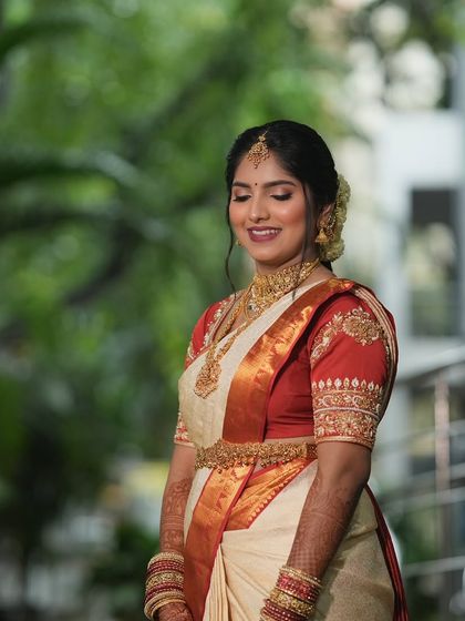 This bride's smile says it all. For her Muhurtham, I created a soft glam look with a focus on glowing skin and shimmery eyes, which looked stunning with her off-white and red Kanjeevaram.