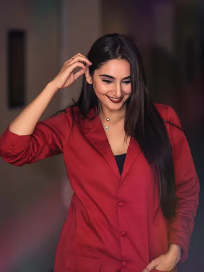 A powerful portrait of Ragini Dwivedi for her brand ambassadorship announcement. The red blazer and direct gaze convey confidence and professionalism, perfect for corporate and commercial campaigns.