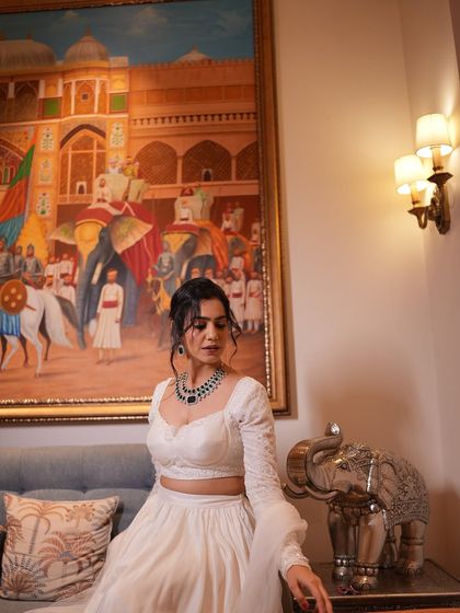Modeling in a regal setting. Dressed in a beautiful white lehenga, this photo showcases my ability to carry ethnic wear with grace, making it ideal for bridal couture or traditional apparel brands.
