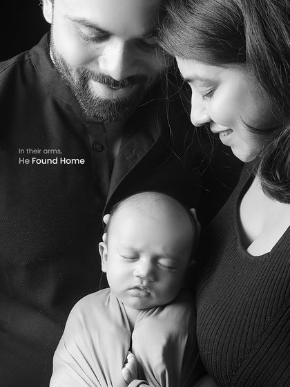 In black and white, the emotion becomes the focus. This intimate portrait captures the feeling of home, with parents gently holding their newborn, creating a powerful and timeless family heirloom.