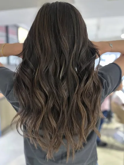 This is a great example of a cool-tone balayage transformation. The result is a sophisticated and modern look, perfect for getting your hair summer-ready.
