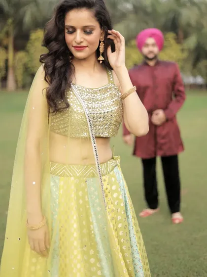 A creative couple shot that highlights the beautiful sequined blouse of the lehenga. We love seeing our clients get creative.
