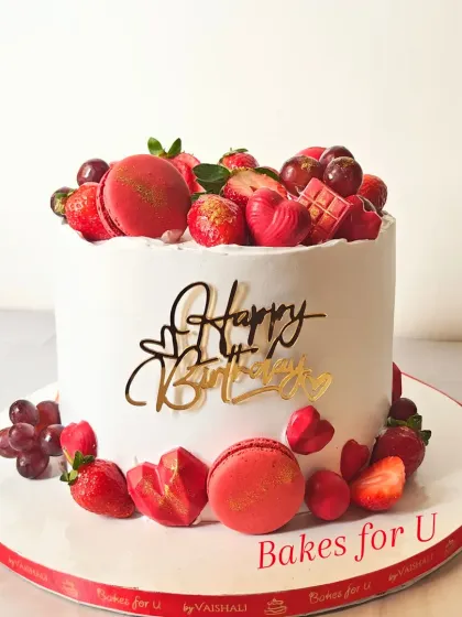 This vibrant birthday cake shows how I love to play with color using natural elements. The design features fresh strawberries, ruby chocolate hearts, and delicate macarons, all arranged on a smooth, white buttercream canvas.