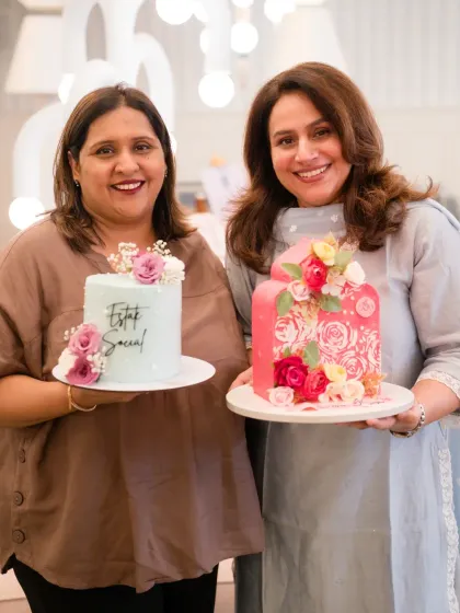 Posing with my pastel blue cake and another beautiful creation at a women's day event.