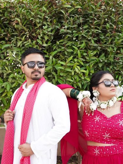 A cool, posed shot of the couple in their sunglasses, bringing a modern twist to their Haldi ceremony.