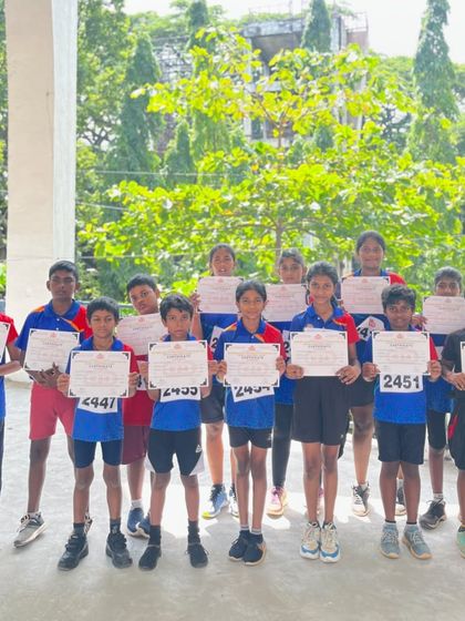 Our group of young athletes proudly displaying their participation certificates from the kids' athletics meet.