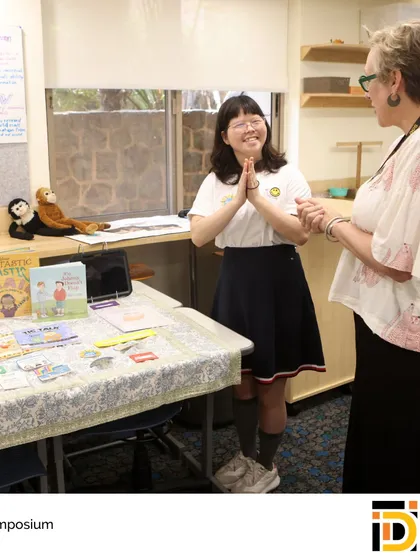 An IDI Capstone student shares her project with a faculty member. The symposium is a celebration of a year-long journey of research, design, and innovation, preparing students for university-level independent work.