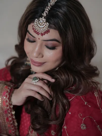 A close-up that feels serene and graceful. This shot highlights the beautiful makeup and jewelry, demonstrating our collaborative process with talented makeup artists for glamour shoots.