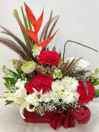 A bold and exotic floral arrangement for Mother's Day. This box features Birds of Paradise, carnations, and lilies, creating a striking and memorable gift.