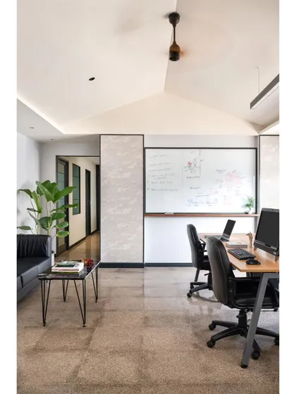 We discovered a hidden gabled roof during this office renovation and decided to make it the centerpiece. The vaulted ceiling transforms a standard workstation area into an open, airy environment. This space shows my belief in adaptive design and finding beauty in unexpected structural elements.