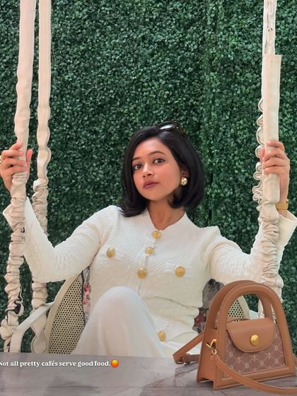 A chic all-white look for a cafe visit. This textured cardigan and pants set with gold buttons has a very classic and elegant feel.