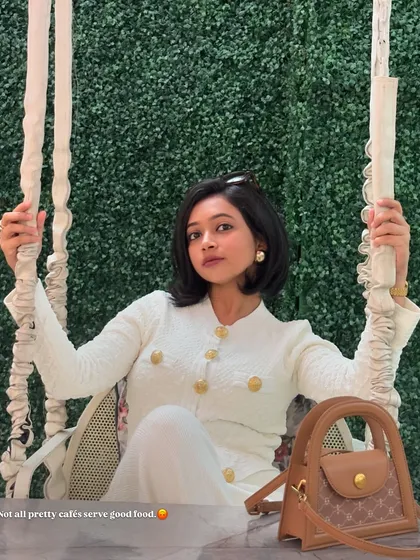 A chic all-white look for a cafe visit. This textured cardigan and pants set with gold buttons has a very classic and elegant feel.