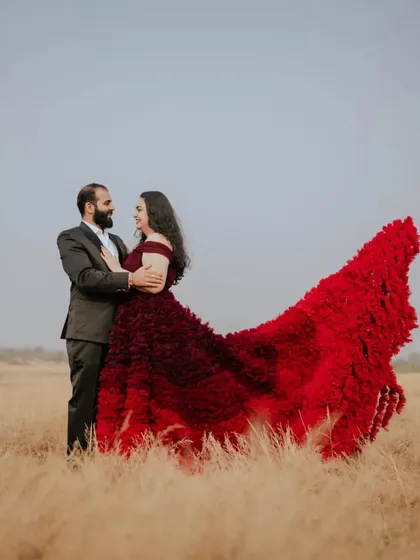 The wind catches the train of this ombre ruffled gown, creating a beautiful, dynamic shape in this open field. It’s a perfect example of how my gowns come to life outdoors.