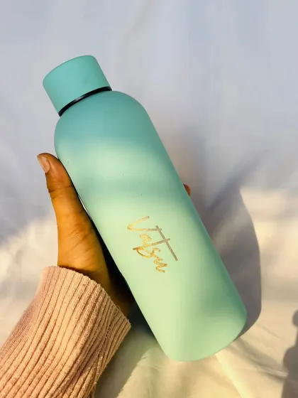 A sleek and simple personalized travel bottle. This pastel blue bottle with a custom name in gold is perfect for staying hydrated on the go.