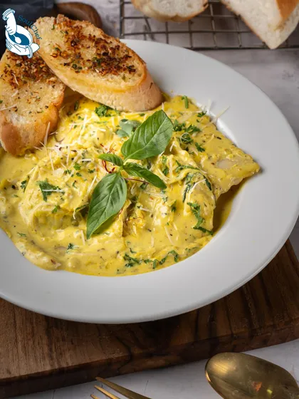Comfort food can also be elegant. My pumpkin-filled ravioli in a velvety sauce, served with fresh basil and garlic bread, is a hearty and sophisticated main course option that is perfect for a formal boardroom dinner or a celebratory team lunch.