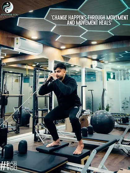 Movement heals. This client is performing a squat on the reformer, a functional exercise that builds lower body and core strength, essential for everyday activities.